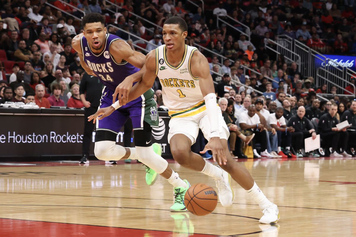 Houston Rockets forward Jabari Smith Jr. drives past Milwaukee Bucks forward Giannis Antetokounmpo